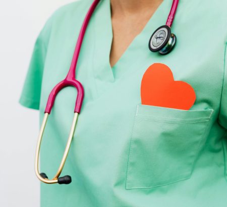 A healthcare professional with a stethoscope and red heart symbol emphasizes cardiology care.
